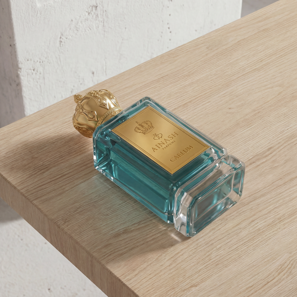 fresh citrus perfume bottle Caelum Ainash Parfums tropical mango pineapple fragrance luxury scent