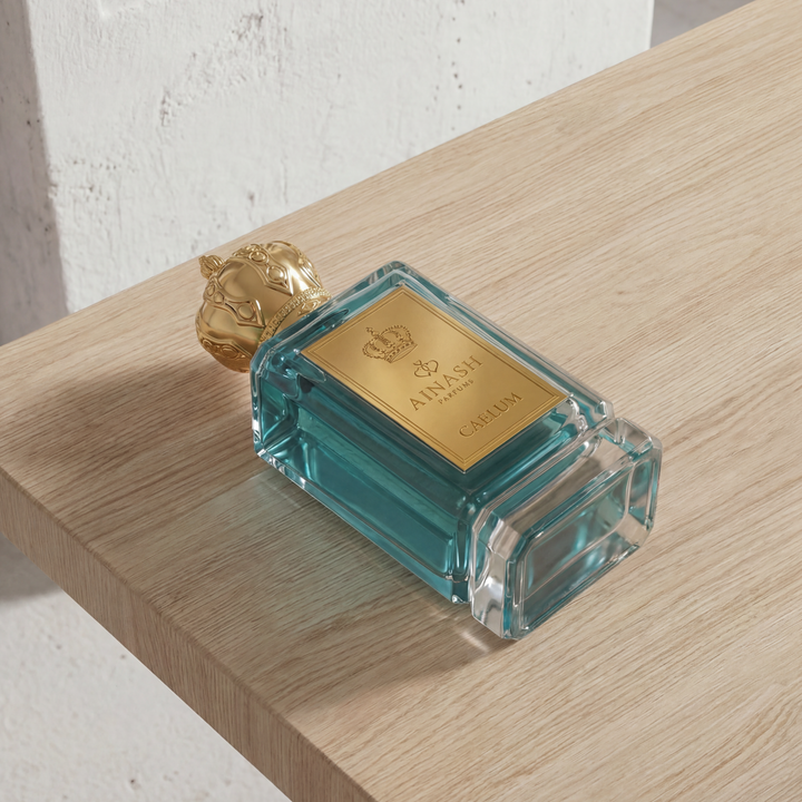 fresh citrus perfume bottle Caelum Ainash Parfums tropical mango pineapple fragrance luxury scent